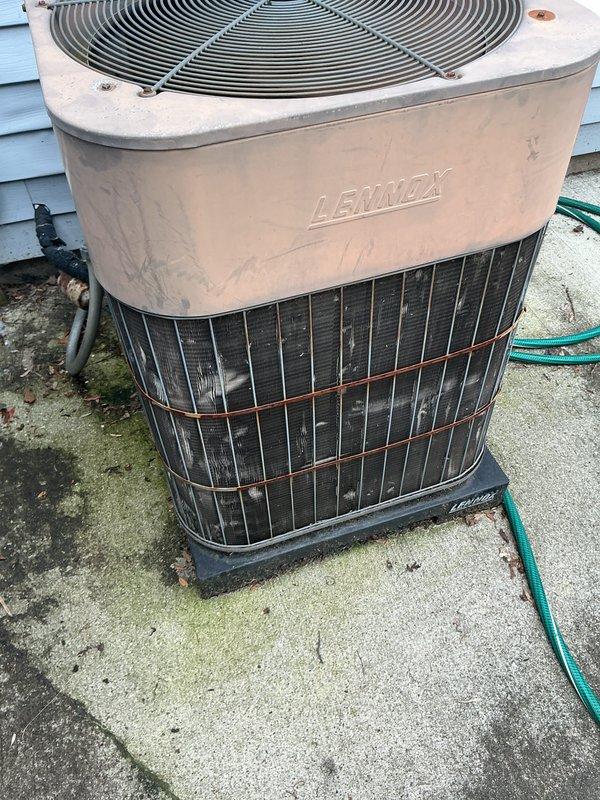 Completed comprehensive AC tune-up on 42-year-old Lennox central air conditioning system. Performed standard preventive maintenance procedures including inspection of outdoor condenser unit, verification of refrigerant levels, cleaning of condenser coils, examination of electrical connections, and testing of system operation. Verified ecobee smart thermostat functionality and confirmed proper communication between thermostat and cooling system. System operating within normal parameters with no deficiencies noted. All components functioning as designed with adequate airflow and temperature differential. Documented equipment condition with photographs showing outdoor condenser unit and indoor thermostat display reading 74 degrees with system set to hold at 68 degrees in cooling mode.