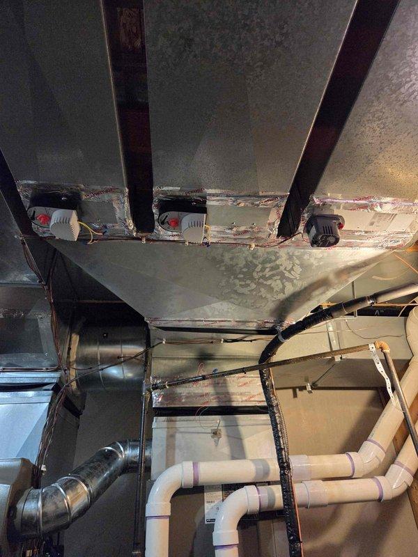 Completed callback installation of 135,000 BTU furnace and air conditioning system with humidifier reconnection. Installed barometric damper between supply and return ductwork to improve system balance. Replaced section of supply trunk line at front of plenum to optimize airflow distribution throughout the system.