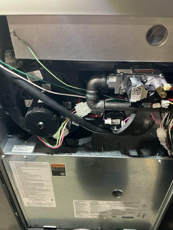 Completed annual maintenance inspection and tune-up on residential furnace and air conditioning system, both approximately two years old and functioning properly. Performed comprehensive evaluation of indoor unit components including gas valve assembly, electrical connections, and motor assembly, confirming all wiring harnesses and safety controls were secure and operational. Inspected outdoor condensing unit positioned on concrete pad, verified proper clearances from landscaping, checked refrigerant levels, and confirmed fan operation and airflow through louvers were within manufacturer specifications.