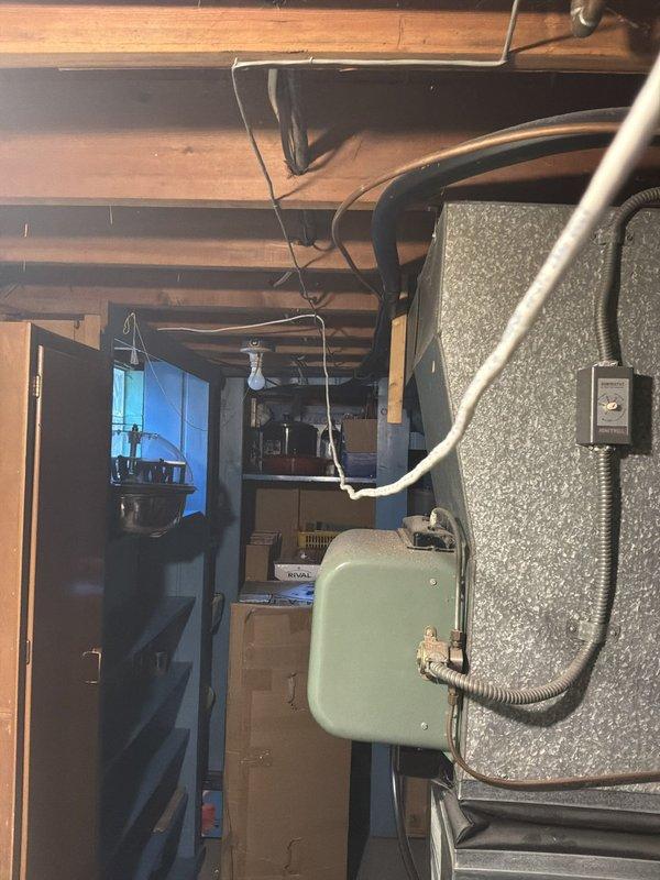 Conducted site evaluation for air conditioning replacement estimate on 20+ year old unit currently located in backyard. Existing AC system is operational but nearing end of service life. Assessed basement mechanical room containing natural gas furnace and water heater, documented existing ductwork configuration, electrical service panel, and utility infrastructure to determine compatibility requirements for new cooling equipment installation.