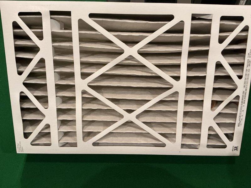 Completed comprehensive 5-year ComfortGuard maintenance visit on HVAC system. Performed thorough inspection of evaporator coil assembly, which showed moderate dust and particulate accumulation on the honeycomb mesh surface with visible discoloration throughout. Inspected drainage line and refrigerant conduit for proper operation and positioning. Removed and evaluated pleated air filter, which displayed dust buildup consistent with normal operational use. Filter frame and internal accordion-style pleated media were examined for structural integrity and airflow restriction. Verified all frame fasteners, rivets, and housing components were secure and properly sealed. System components were documented photographically for maintenance records.