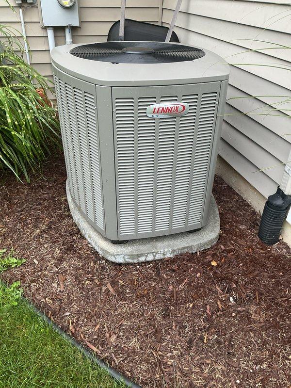Completed complimentary air conditioning maintenance inspection on a 2-year-old Lennox Elite residential cooling system. Unit is operating within normal parameters with no reported issues or concerns. Performed standard preventive maintenance tune-up procedures including visual inspection of outdoor condenser unit, verification of proper airflow through louvered cabinet, assessment of installation integrity on concrete pad, and confirmation of adequate clearance from structure and landscaping. System shows excellent condition consistent with age, with clean exterior surfaces and well-maintained surrounding area. All components functioning properly at time of service.