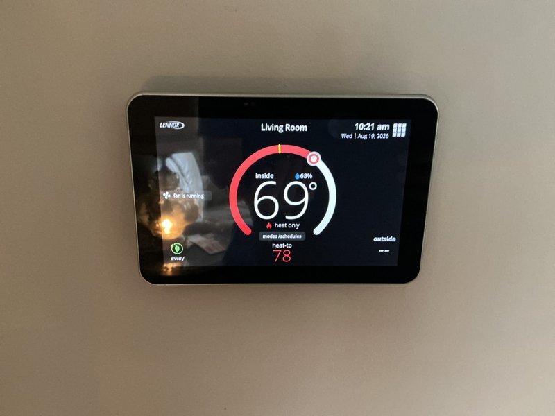 Completed comprehensive ComfortGuard Maintenance visit including replacement of air filters and evaporator pads as part of the 5-year recurring service program. Verified proper operation of Lennox smart thermostat system showing heating mode functionality with accurate temperature readings and scheduling features. All HVAC system components inspected and confirmed operational within normal parameters.