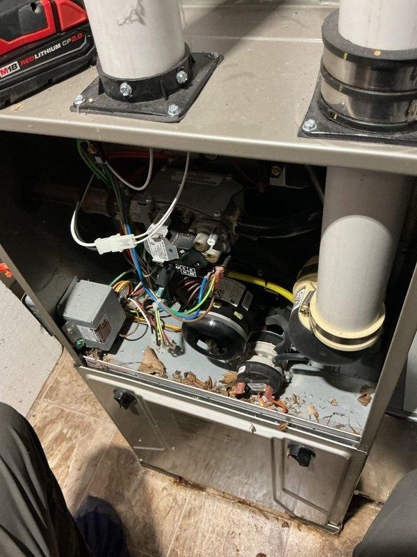 Responded to emergency service call for reported gas odor from 7-year-old furnace in basement, which had been shut down for safety. Upon arrival, performed comprehensive safety inspection of gas furnace and all connections. Inspected blower motor assembly, gas valve, electrical connections, and all internal components for potential gas leaks or failures. Examined combustion chamber, heat exchanger, and burner assembly for cracks or deterioration that could cause gas odor. Tested all gas line connections, fittings, and the main gas valve using leak detection methods. Verified proper venting through PVC intake and exhaust pipes. Cleaned debris from interior cabinet and checked all wiring harnesses and electrical connections for damage. Inspected condensate drain system and associated plumbing connections. Unit required further evaluation to determine source of gas odor before safe return to operation.