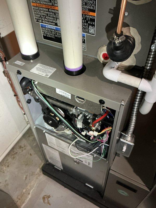 Completed annual heating and cooling maintenance on residential HVAC system. Performed electrical diagnostics using multimeter, recording voltage readings of 513V on system components. Identified and documented filter replacement requirement for HCF16-11 MERV 11 filter. Inspected furnace unit with all internal components including control boards, wiring, and mechanical systems. Verified proper operation of PVC intake and exhaust venting, copper refrigerant lines, and flexible ductwork connections. All safety labels and manufacturer specifications documented and visible on equipment.