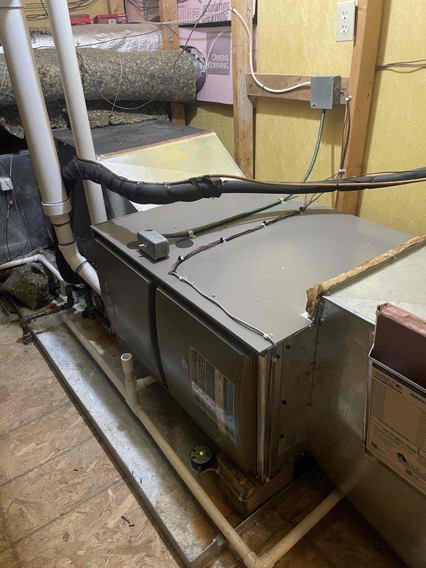 Successfully installed two high-efficiency furnaces in basement location: one 110,000 BTU unit and one 90,000 BTU unit. Both systems were mounted on wooden platforms with proper clearances, connected to existing ductwork using flexible ducting, and vented to exterior using white PVC intake and exhaust piping. Electrical connections were completed with appropriate conduit and junction boxes, all work performed to code specifications under mechanical permit for furnace replacement and reconnection.