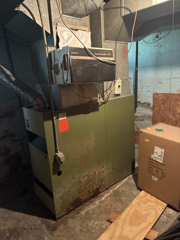 Conducted estimate for replacement of 50-year-old natural gas furnace located in basement. Current unit is operational but has reached end of service life, with basement showing signs of moisture damage and deteriorated conditions around existing HVAC equipment. Provided replacement options for modern high-efficiency furnace system to improve heating performance and reliability.