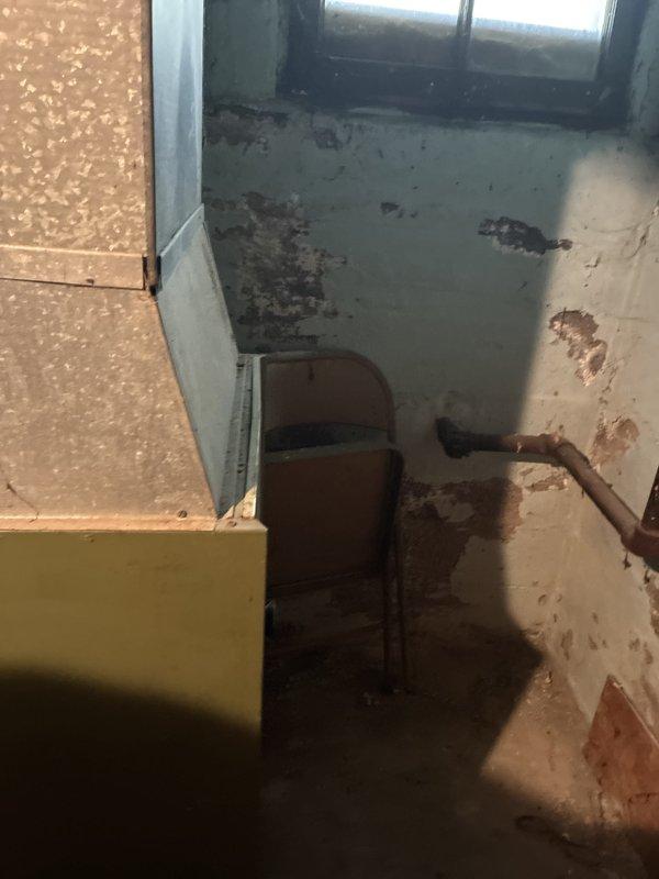 Conducted estimate for replacement of 50-year-old natural gas furnace located in basement. Current unit is operational but has reached end of service life, with basement showing signs of moisture damage and deteriorated conditions around existing HVAC equipment. Provided replacement options for modern high-efficiency furnace system to improve heating performance and reliability.
