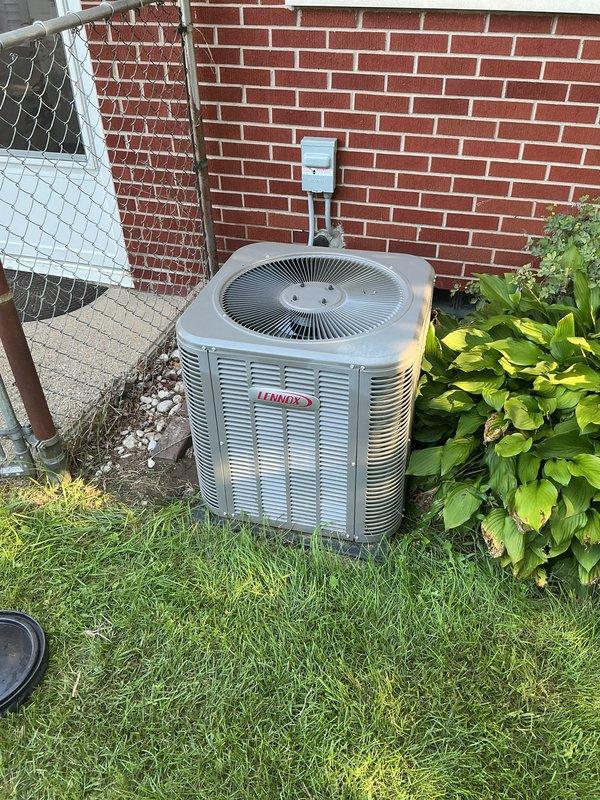Completed annual cooling maintenance on Lennox outdoor condensing unit. Performed comprehensive system inspection including electrical disconnect verification, condenser coil examination, and operational assessment. Unit found in proper working condition with adequate clearances from surrounding landscaping and brick foundation wall.
