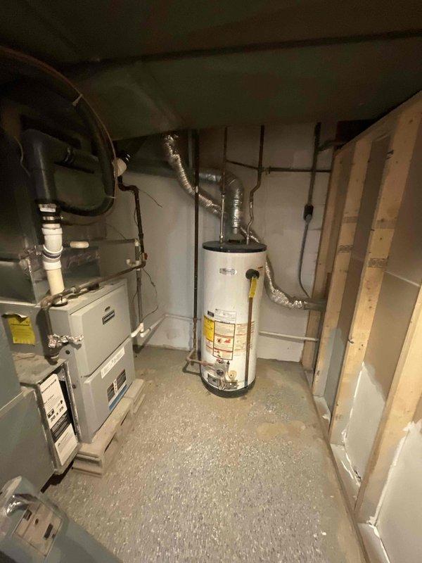 Performed comprehensive evaluation of 16-year-old central air conditioning system experiencing inadequate cooling distribution throughout residence. Assessed existing HVAC equipment in basement mechanical room, including furnace/air handler unit and associated ductwork configuration. Provided full system replacement estimate to address aging equipment and uneven temperature control issues affecting multiple rooms.