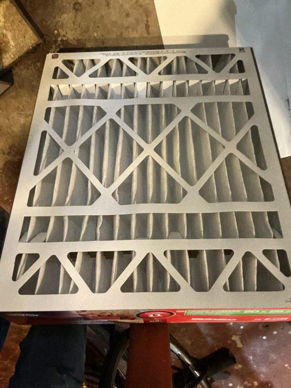 Completed annual cooling maintenance inspection on HVAC system. Inspected and photographed air filter condition, confirming proper pleated media installation with X-shaped reinforcement structure. Verified thermostat operation on Lux 500 programmable model, displaying proper functionality at 67°F setpoint with all programming features and mode controls operational. System components inspected and found to be in satisfactory working condition for continued seasonal operation.