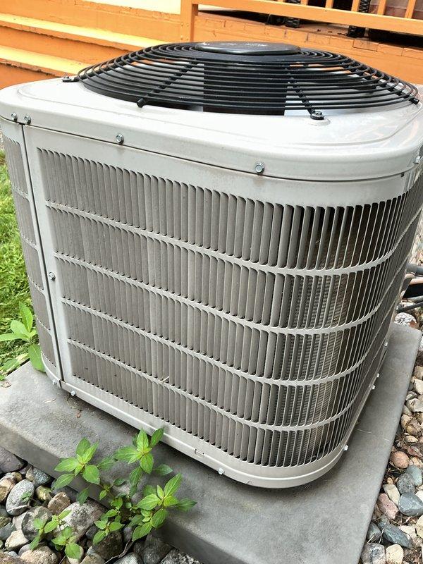 Completed annual cooling maintenance on Bryant residential air conditioning system. Performed comprehensive inspection of indoor and outdoor components, including thermostat operation verification, condenser unit examination, and filter replacement as part of routine preventive maintenance service. System operating properly with thermostat displaying 70°F in cooling mode and outdoor condenser unit showing normal wear consistent with regular operation.