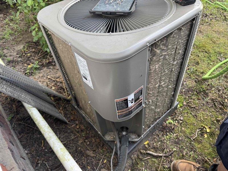 Completed routine maintenance and tune-up on a 4-year-old residential air conditioning system with no reported performance issues. Performed comprehensive inspection of outdoor condenser unit, which showed normal weathering and dirt accumulation consistent with outdoor exposure. Cleaned condenser coils and exterior surfaces, checked refrigerant levels, verified electrical connections, inspected fan operation, and confirmed all components were functioning within manufacturer specifications for optimal system performance.