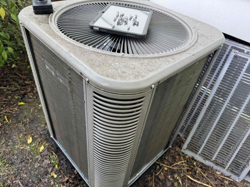 Completed routine maintenance and tune-up on a 4-year-old residential air conditioning system with no reported performance issues. Performed comprehensive inspection of outdoor condenser unit, which showed normal weathering and dirt accumulation consistent with outdoor exposure. Cleaned condenser coils and exterior surfaces, checked refrigerant levels, verified electrical connections, inspected fan operation, and confirmed all components were functioning within manufacturer specifications for optimal system performance.
