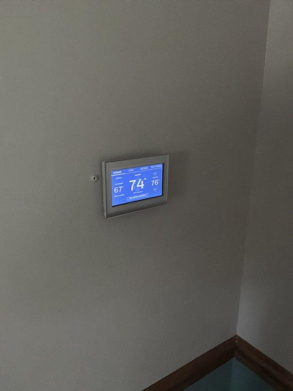 Conducted full system estimate for replacement of existing 16-year-old heating and cooling equipment in residential basement installation. Evaluated current furnace and ductwork configuration, documented existing thermostat operation displaying 74°F current temperature, and assessed mechanical room layout including water heater proximity and available space for new equipment installation. Customer seeking replacement within the next couple weeks; provided comprehensive estimate for complete HVAC system replacement including furnace, air conditioning unit, and any necessary ductwork modifications.