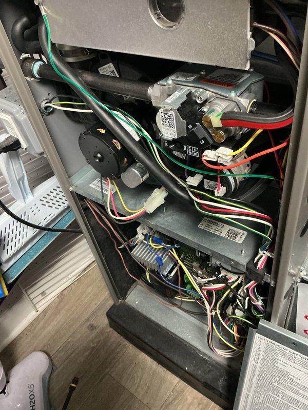 Responded to callback for ComfortGuard Maintenance follow-up to address concerns from previous visit. Accessed furnace cabinet in basement and replaced severely damaged and overloaded air filter that had been left shredded. Reinstalled access panel cover that had been left off during prior service visit. Performed complete furnace inspection including verification of all electrical connections, motor assembly, capacitors, and control boards. Inspected wiring harnesses, ground connections, and safety controls throughout the unit. Confirmed proper operation of all mechanical and electrical components. Addressed thermostat alert issues reported by homeowner. System now operating within normal parameters with all access panels properly secured and new filter installed.
