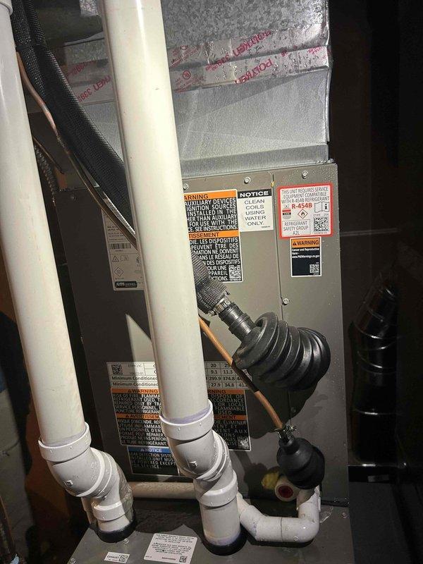 Responded to service call for loud noise complaint on one-year-old air conditioning system located in basement. Upon inspection, identified vibration or loose component issue within the HVAC system. Performed diagnostic evaluation of air handler unit, refrigerant lines, and associated ductwork connections. Documented equipment condition and noise source through photographic evidence. Repairs completed under active parts and labor warranty coverage.