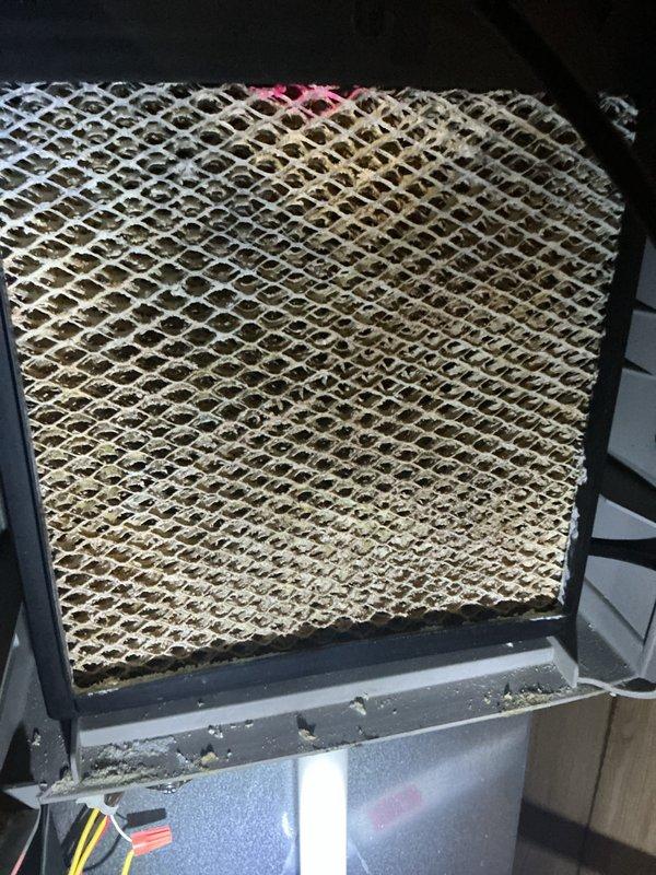 Performed comprehensive AC tune-up on central air conditioning system for long-time client. Conducted full system inspection including evaporator coil assessment, which revealed significant dust and debris accumulation requiring attention. Verified thermostat operation with Bryant unit displaying proper temperature reading of 70°F with all controls functioning correctly. Completed standard maintenance protocol including visual inspection of electrical connections, filter evaluation, and system performance verification. Unit operating within normal parameters at service completion with no immediate concerns identified, though evaporator coil showed evidence of extended service period without cleaning.