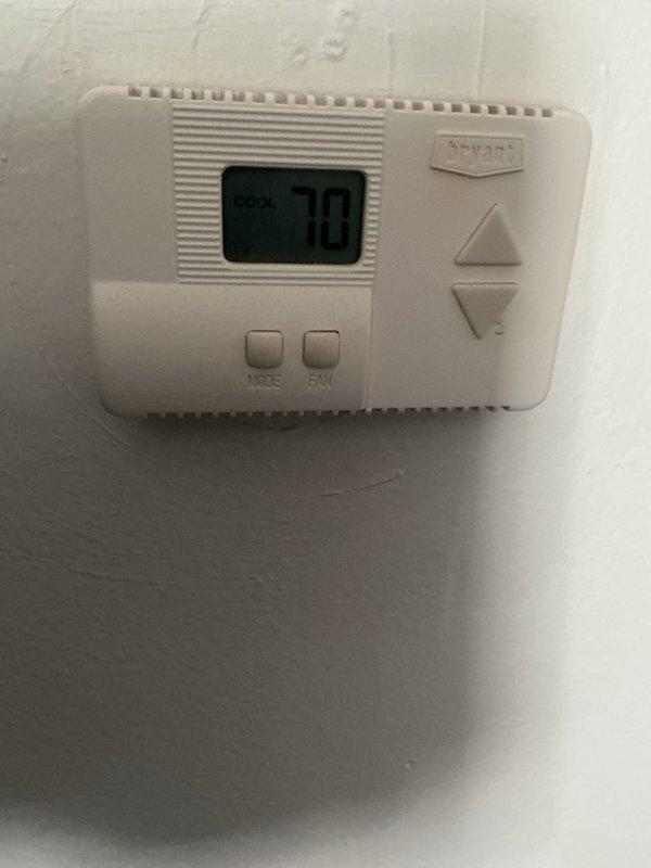 Performed comprehensive AC tune-up on central air conditioning system for long-time client. Conducted full system inspection including evaporator coil assessment, which revealed significant dust and debris accumulation requiring attention. Verified thermostat operation with Bryant unit displaying proper temperature reading of 70°F with all controls functioning correctly. Completed standard maintenance protocol including visual inspection of electrical connections, filter evaluation, and system performance verification. Unit operating within normal parameters at service completion with no immediate concerns identified, though evaporator coil showed evidence of extended service period without cleaning.