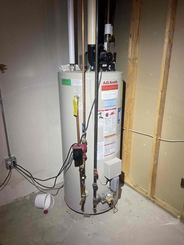Provided comprehensive estimate for tankless water heater replacement to replace existing conventional A.O. Smith tank-style water heaters currently installed in basement utility area. Assessment included evaluation of current venting configuration through exterior wall, existing copper and black iron gas piping, electrical requirements, and necessary modifications to accommodate tankless unit installation with proper combustion air and exhaust venting systems.