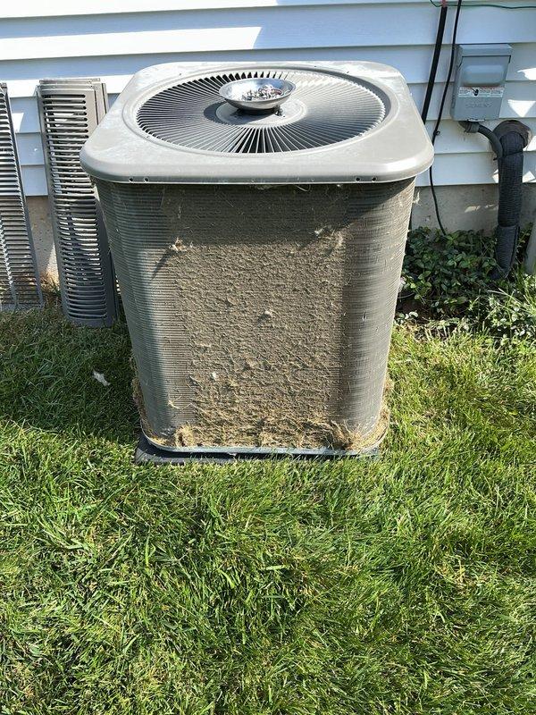 Completed scheduled ComfortGuard maintenance visit for residential HVAC system. Performed comprehensive inspection of outdoor air conditioning condenser unit, which exhibited significant debris accumulation on exterior fins and louvers requiring attention. Replaced furnace air filter as part of routine preventative maintenance protocol to ensure optimal system airflow and efficiency.