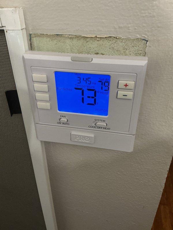 Completed routine furnace maintenance and tune-up on a 5-year-old heating system located in basement. System was found operating properly with thermostat maintaining accurate temperature control at 73 degrees. Inspected evaporative cooler pad which showed moderate accumulation of dust and particulate matter throughout the honeycomb mesh filter material, with heavier buildup concentrated in center sections. All components tested and confirmed functioning within normal parameters.