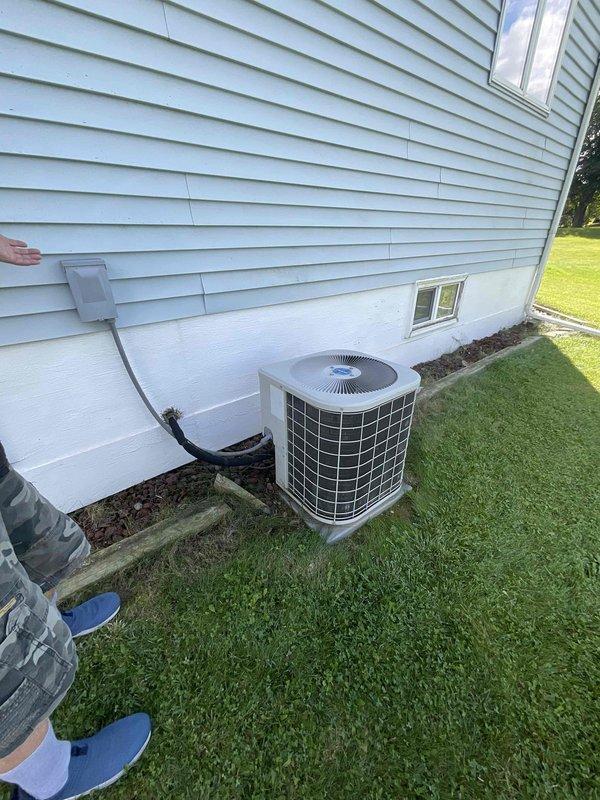 Provided estimate for complete HVAC system replacement including air conditioning unit and furnace for non-operational equipment originally installed in 1989. Assessed existing outdoor condenser unit on concrete pad and basement-located furnace with associated ductwork, documenting current system configuration and discussing available replacement options including promotional offers.