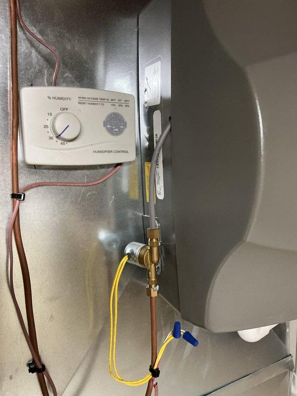 Completed comprehensive 5-year recurring ComfortGuard maintenance service on residential HVAC system. Performed thorough inspection of furnace/air handler unit, humidifier control system with humidity settings verified operational, and associated refrigerant line assembly. Examined all copper tubing, PVC condensate drain routing with trap configuration, insulated refrigerant lines, and connection points for proper installation and function. Verified humidifier control panel calibration, inspected brass fittings and valve operations, and confirmed all mechanical components operating within manufacturer specifications. System found in good working condition with no immediate service needs identified.