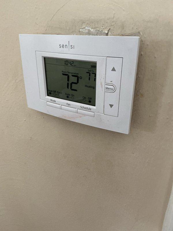 Completed routine AC tune-up on 6-year-old outdoor condensing unit with no reported issues or concerns. Performed standard preventative maintenance procedures including system inspection, thermostat verification (Sensi digital model reading 72°F in heating mode), and equipment assessment. Furnace model TM9V090B12MP11A located in basement was observed but not serviced per customer request, with tune-up limited to air conditioning system only.