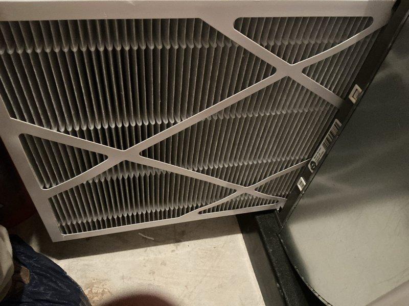 Completed routine annual maintenance on a one-year-old central air conditioning system located in basement. Performed comprehensive tune-up including inspection of all major components, verified refrigerant levels, checked electrical connections, and tested system operation. Installed new pleated air filter with cardboard frame and diagonal support struts. Confirmed smart thermostat functioning properly, displaying set temperature of 65°F with current reading of 69°F in cooling mode. All system parameters within normal operating range with no deficiencies noted. Unit operating efficiently with no reported issues or symptoms from occupant.