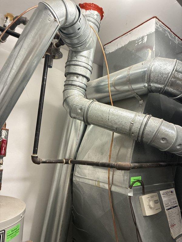 Provided comprehensive estimate for complete HVAC system replacement including furnace and air conditioning unit for a 2005 home with forced air system located in main level utility closet. Evaluated existing natural gas furnace, air handler, humidifier integration, and ductwork configuration, documenting current system layout with metal supply and return ducts, copper refrigerant lines, and PVC humidifier piping. Assessment included review of existing water heater proximity and utility closet space constraints for proper equipment sizing and installation planning.