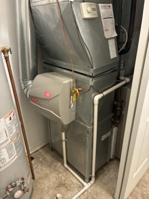 Provided comprehensive estimate for complete HVAC system replacement including furnace and air conditioning unit for a 2005 home with forced air system located in main level utility closet. Evaluated existing natural gas furnace, air handler, humidifier integration, and ductwork configuration, documenting current system layout with metal supply and return ducts, copper refrigerant lines, and PVC humidifier piping. Assessment included review of existing water heater proximity and utility closet space constraints for proper equipment sizing and installation planning.