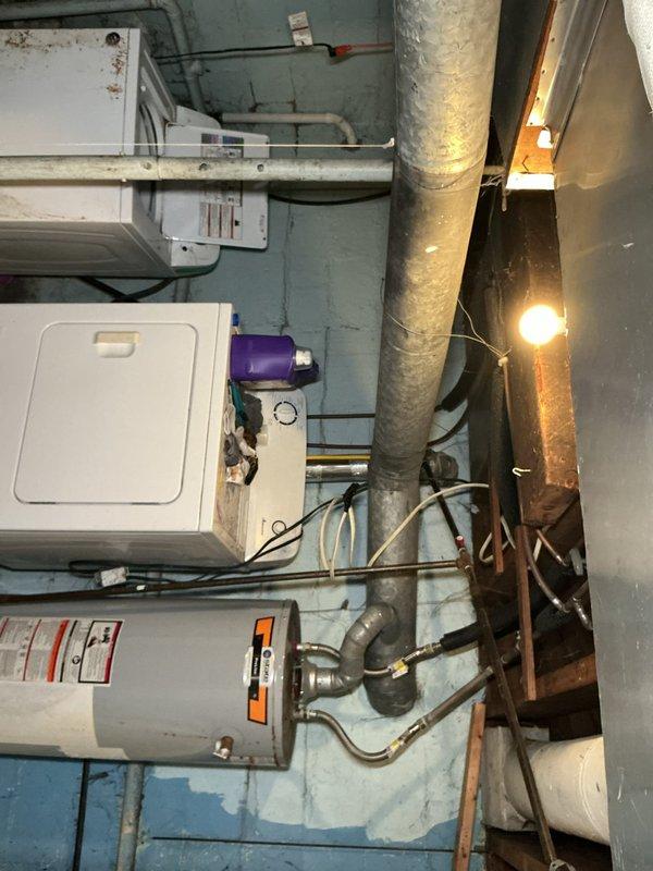 # Tanked Water Heater Service

Responded to service call for water heater system located in basement utility area. Upon arrival, conducted comprehensive inspection of State-brand tanked water heater unit and associated plumbing connections. Examined all copper supply lines, brass fittings, shutoff valves, and flexible connectors for proper operation and potential issues.

Inspected water heater tank exterior for signs of corrosion, leakage, or structural concerns. Verified proper venting configuration and clearances around unit. Tested all shutoff valves with red handles for proper function and accessibility. Examined compression fittings and connection points for signs of weeping or deterioration. Assessed condition of pipe insulation on vertical supply lines.

Documented existing system configuration including copper piping, brass valves, and flexible connectors. Photographed installation for service records, noting age-related discoloration on metal components and overall system con