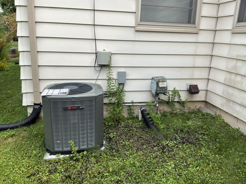Conducted on-site assessment for whole house natural gas standby generator installation. Evaluated existing electrical infrastructure including main service panel, meter location, and available space adjacent to Trane AC unit on concrete pad. Documented current electrical service configuration, meter box positioning, and conduit routing to determine optimal generator placement and transfer switch installation requirements. Photographed exterior electrical components and potential generator location to develop comprehensive installation proposal for automatic backup power system.