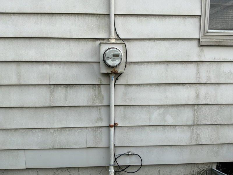Conducted on-site assessment for whole house natural gas standby generator installation. Evaluated existing electrical infrastructure including main service panel, meter location, and available space adjacent to Trane AC unit on concrete pad. Documented current electrical service configuration, meter box positioning, and conduit routing to determine optimal generator placement and transfer switch installation requirements. Photographed exterior electrical components and potential generator location to develop comprehensive installation proposal for automatic backup power system.