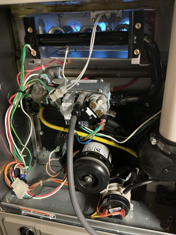 Completed routine fall furnace maintenance and tune-up on 10-year-old unit prior to heating season. Performed comprehensive system inspection including blower motor assembly, gas valve controls, ignition components, electrical connections, and wiring harnesses. Verified all mechanical connections secure, tested gas control valves and burner assembly, confirmed proper wire routing throughout compartment, and measured system temperatures to ensure unit operating within normal parameters. All components found in good working condition with no issues identified.