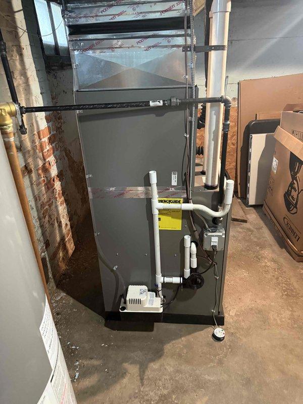 Completed full HVAC system installation in residential basement, including Bryant 70,000 BTU furnace with proper venting via white PVC intake and exhaust piping, 2-ton air conditioning unit with rear placement configuration, and matching evaporator coil. Installed new refrigerant lines with copper piping, connected all ductwork to existing distribution system, and ran new dedicated electrical circuit to code. Applied for and obtained mechanical and electrical permits prior to installation. All equipment mounted, leveled, and secured to manufacturer specifications with condensate drainage properly configured. System tested for proper operation, airflow, and temperature differential upon completion.