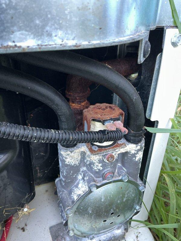 Responded to service call for Generac generator displaying red warning light indicator. Performed comprehensive diagnostic inspection of unit, revealing heavily corroded contactor assembly and deteriorated control components due to prolonged moisture exposure. Documented equipment condition with detailed photographs showing advanced rust on cylindrical contactor element and weathered junction box housing. Inspection confirmed unit required component replacement to restore proper operation, with all findings reported and work approved by municipal inspection authority.