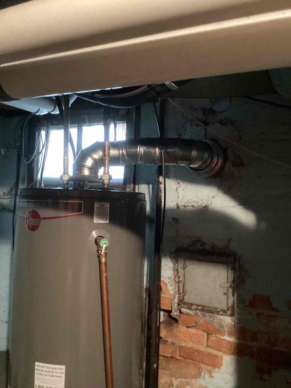 Completed full HVAC system installation including 70,000 BTU furnace with chimney liner, 2-ton air conditioning unit with evaporator coil positioned at rear of system, and dedicated electrical circuit. Obtained mechanical and electrical permits prior to installation, documented completed work with interior equipment photos and exterior chimney cap installation.
