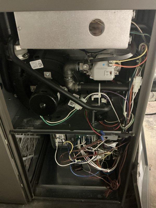 Completed comprehensive annual maintenance on 3-year-old residential HVAC system including both furnace and air conditioner units. Performed full system inspection with access panel removal to examine internal components, electrical connections, gas valve assembly, heat exchanger, and blower motor. Verified all wire harnesses, control modules, and capacitor connections were secure and properly labeled. Inspected condensate drainage system, burner assembly, and ductwork connections. Tested system operation and confirmed both heating and cooling functions performing within normal parameters with no deficiencies noted.