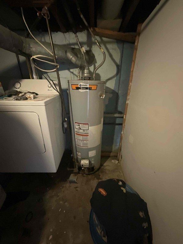Assessed aging HVAC system and water heater in basement utility area where repair costs would exceed replacement value. Provided comprehensive estimate for full system replacement package including furnace, air conditioning unit, and water heater, as well as standalone water heater replacement option for homeowner consideration.