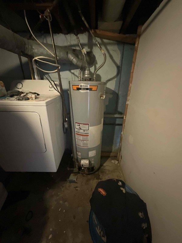 Assessed aging HVAC system and water heater in basement utility area where repair costs would exceed replacement value. Provided comprehensive estimate for full system replacement package including furnace, air conditioning unit, and water heater, as well as standalone water heater replacement option for homeowner consideration.