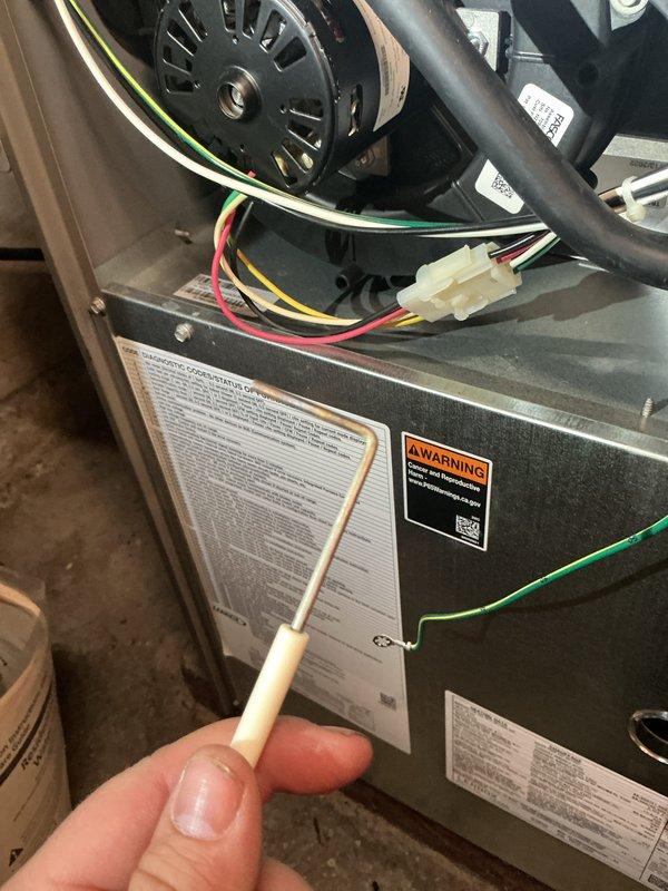 Completed routine AC tune-up and maintenance on 4-year-old Lennox system. Performed electrical diagnostics using multimeter, verifying proper voltage readings at 531V on system components. Inspected furnace interior components, blower motor operation, and electrical connections; confirmed all wiring secure and system operating within normal parameters.