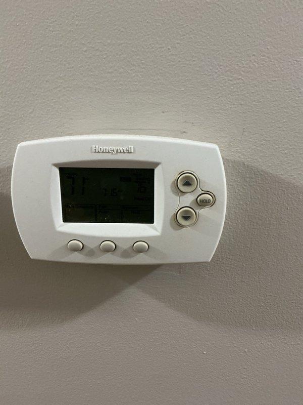 Completed routine AHM preventive maintenance service on HVAC system. Inspected Honeywell digital thermostat for proper operation and verified all control functions. Replaced heavily soiled air filter with accumulated dust and debris to restore proper airflow and system efficiency.