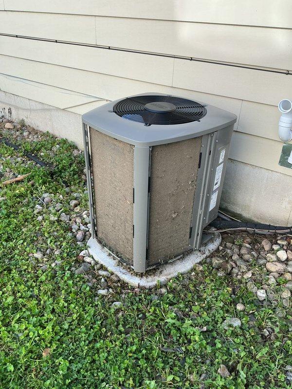 Completed annual HVAC maintenance on residential air conditioning system. Inspected outdoor condenser unit, verified operational status of all components including fan motor and compressor, and noted humidifier pads require replacement. Honored previously expired maintenance visit as authorized, documented equipment condition with photos showing unit exterior and installation site.