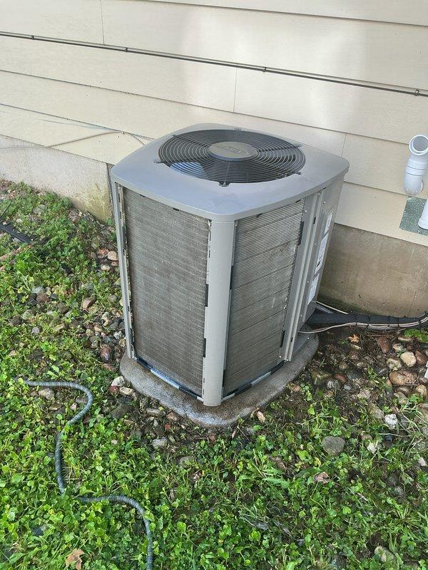 Completed annual HVAC maintenance on residential air conditioning system. Inspected outdoor condenser unit, verified operational status of all components including fan motor and compressor, and noted humidifier pads require replacement. Honored previously expired maintenance visit as authorized, documented equipment condition with photos showing unit exterior and installation site.