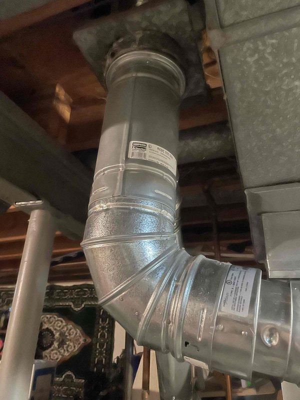 Completed full installation of Lennox air conditioning system and evaporator coil at residential property. Outdoor condensing unit positioned on concrete pad against exterior brick wall with proper electrical disconnect and conduit installation. Indoor evaporator coil installed in ductwork system between ceiling joists with metallic supply plenum connections, secured with metal bands and proper sealing at all joints. All ductwork connections completed with rigid and flexible components as required. System installed per manufacturer specifications and ready for operation.