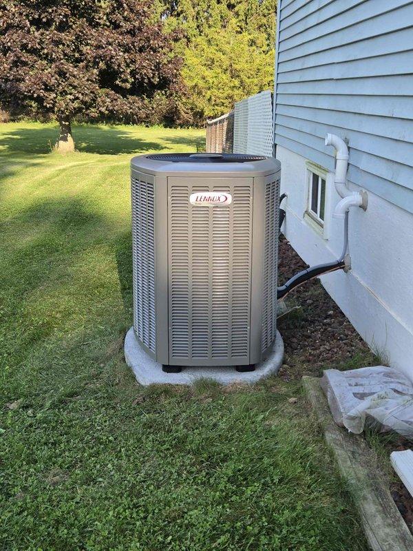 Completed full HVAC system installation including a 70,000 BTU furnace, 2-ton air conditioning unit, and evaporator coil. Installed Lennox outdoor condensing unit on concrete pad with proper refrigerant line connections and PVC drainage piping routed along exterior wall. Positioned equipment for right-side configuration and reconnected all electrical components. All ductwork properly secured and insulated in basement utility area, with system tested and verified operational upon completion.
