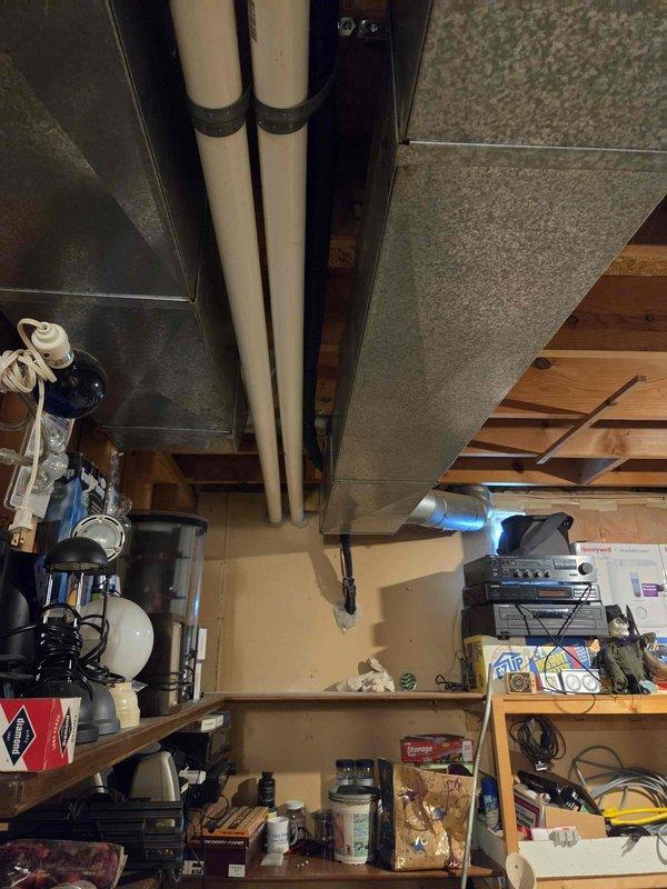 Completed full HVAC system installation including a 70,000 BTU furnace, 2-ton air conditioning unit, and evaporator coil. Installed Lennox outdoor condensing unit on concrete pad with proper refrigerant line connections and PVC drainage piping routed along exterior wall. Positioned equipment for right-side configuration and reconnected all electrical components. All ductwork properly secured and insulated in basement utility area, with system tested and verified operational upon completion.