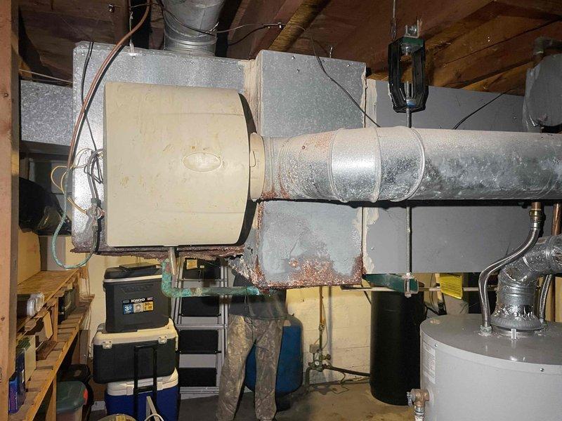 Completed full system replacement estimate for residential HVAC equipment including 30+ year old gas furnace located in basement and matching-age central air conditioning condenser unit positioned on exterior concrete pad. Documented existing system configuration, ductwork connections, and equipment specifications through photographic assessment. Provided comprehensive replacement options for complete heating and cooling system upgrade to improve efficiency and reliability.